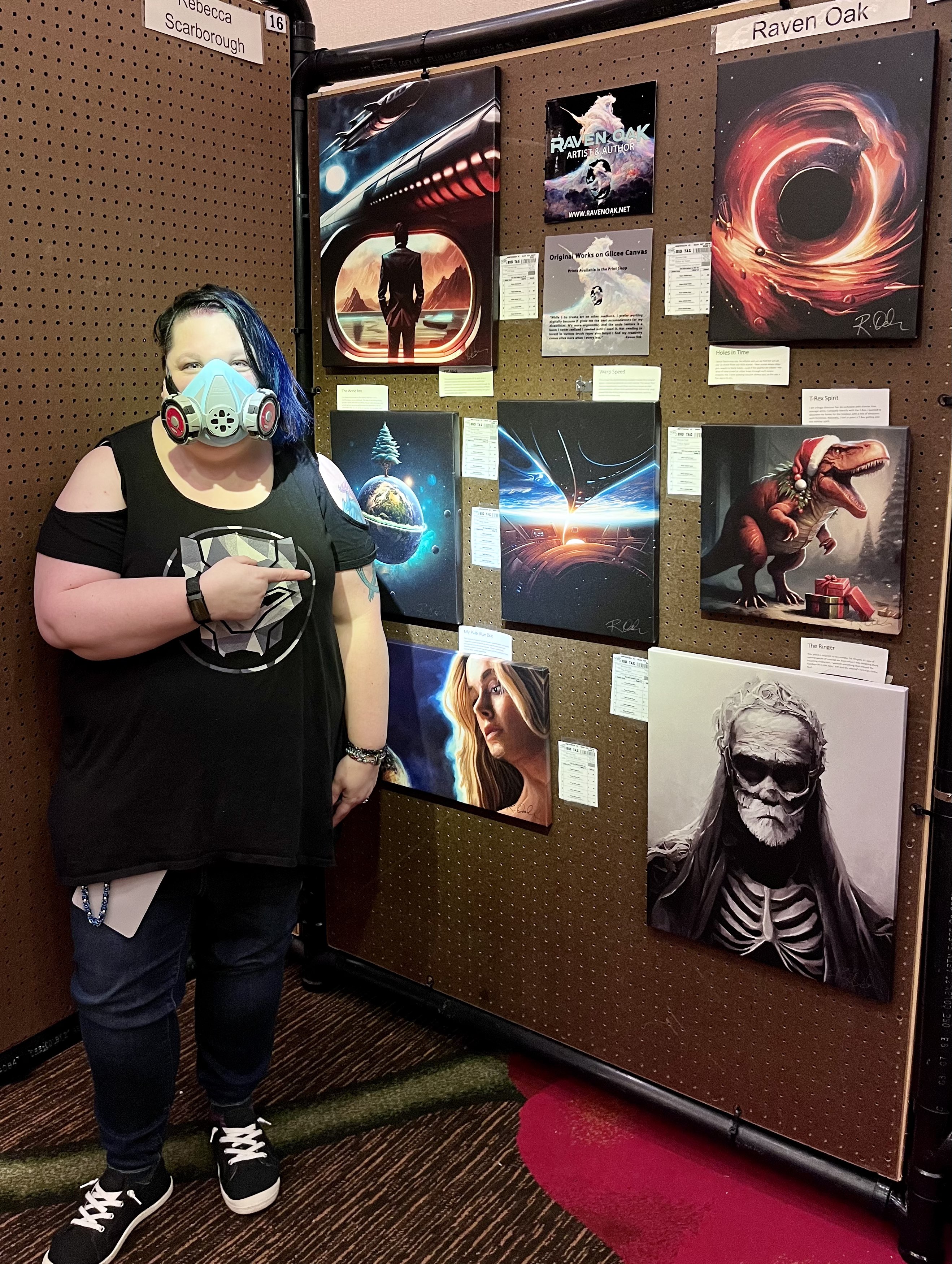 Artist Raven Oak in front of her art work at Norwescon 45's art show